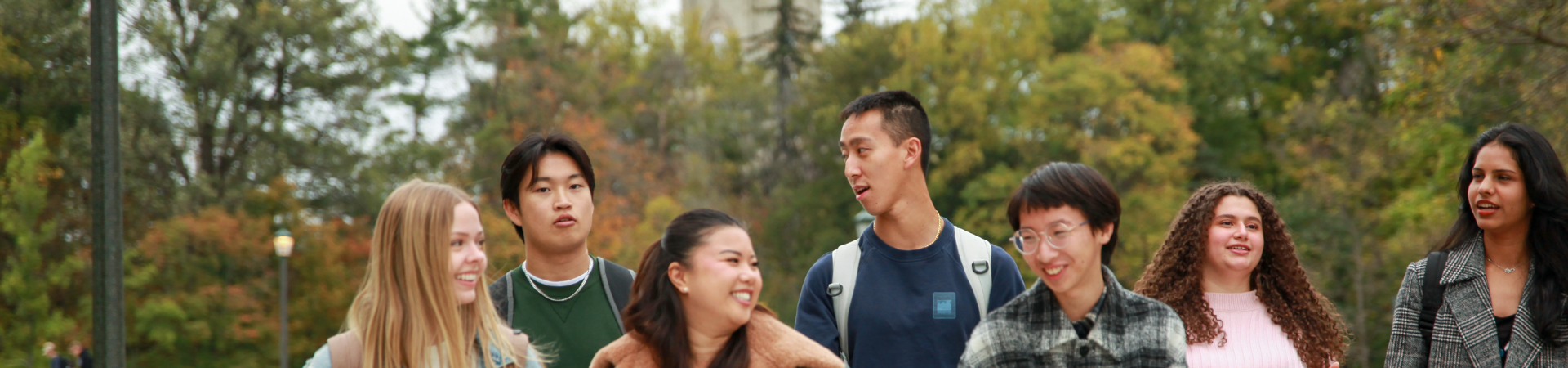 Students looking at a white board, with one student actively writing.